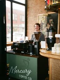 Espresso machine and barista at Mercury Coffee Co. Espresso machine and barista at Mercury Coffee Co.