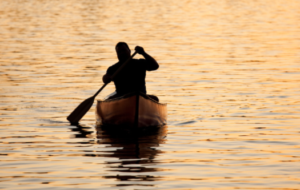 Visitor paddling in a kayak on Canadice Lake Visitor paddling in a kayak on Canadice Lake