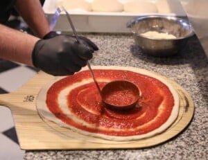 Prepping pizza at Pizza NOTA Prepping pizza at Pizza NOTA